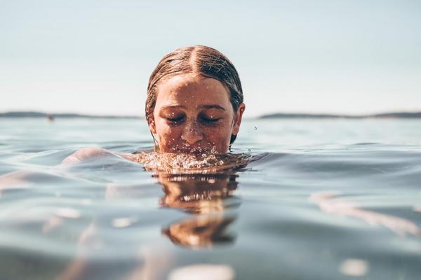 Girl snorkeling with fishes