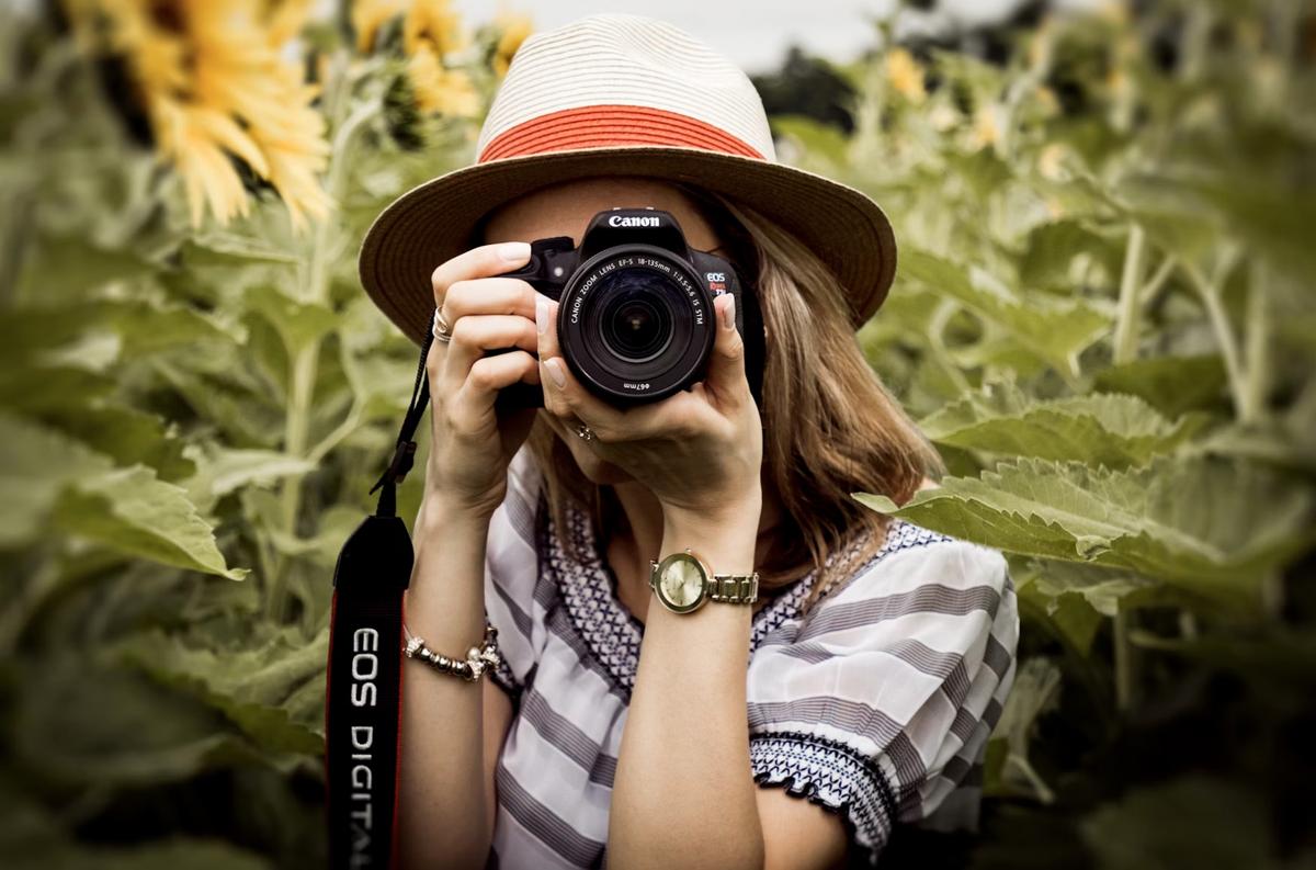 woman taking photo of plants